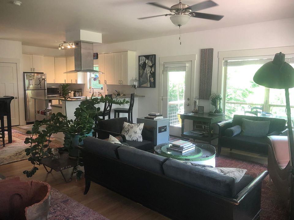 View of living room with kitchen in background