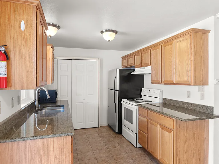 Full kitchen, granite counters, stainless steel fridge, electric oven, dishwasher.