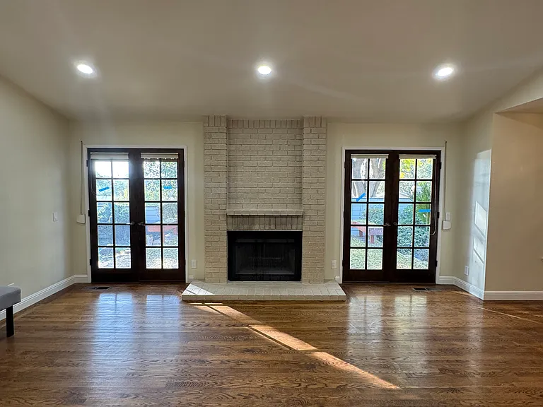 Dual patio yard doors with brick fireplace