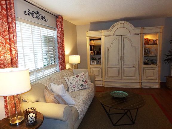 A large window gives light throughout the day into the living room.