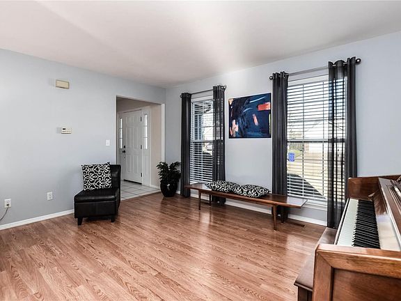 Spacious front living room with laminate wood flooring