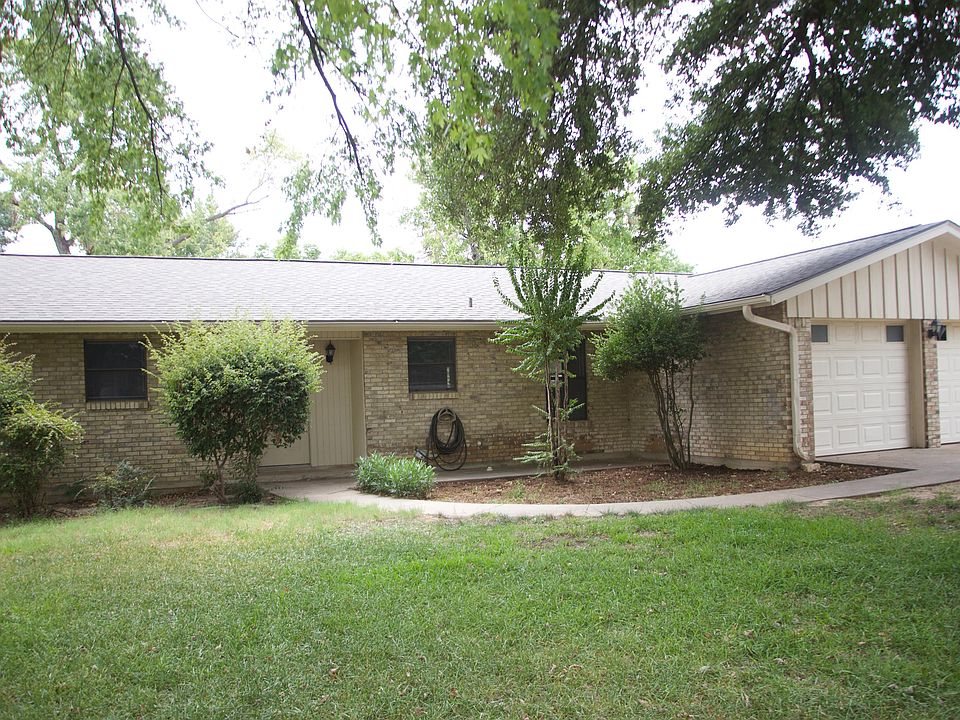 Living room with fireplace, new flooring, access to fenced backyard