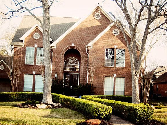 Beautiful red brick home at 1710 Rambling Stone Drive - one of the most picturesque tree lined stree