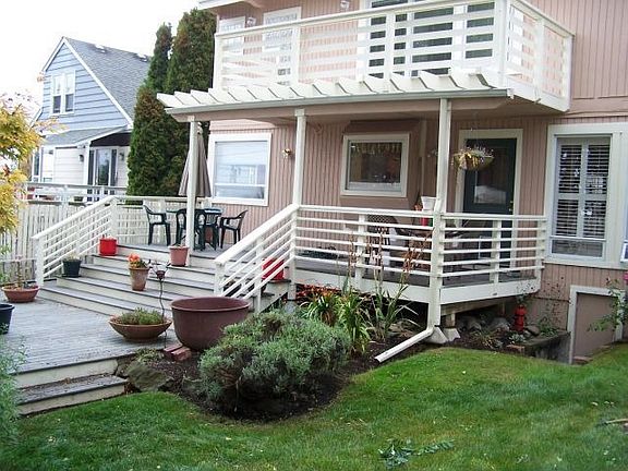 Tranquil rear yard is great for entertaining, & lower patio/deck is covered.