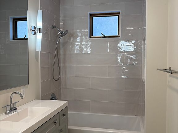 Clean, updated bathroom with modern fixtures, tub/shower combination, and natural light. Designed for comfort and functionality.