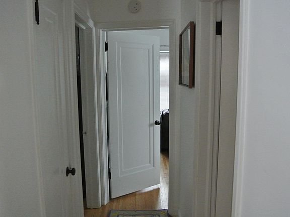 Facing down the hallway towards the bedrooms. Kitchen to the right and living room to the left. Bathroom is the first door on right across from pantry. The 2 bedrooms at the end.