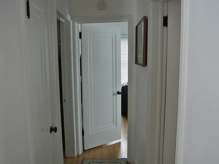 Facing down the hallway towards the bedrooms. Kitchen to the right and living room to the left. Bathroom is the first door on right across from pantry. The 2 bedrooms at the end.