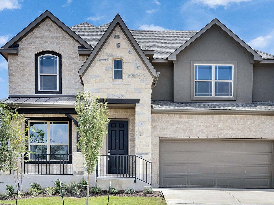 Luxurious stone facade with wood accents defines this elegant Georgetown residence at Oaks at San Ga
