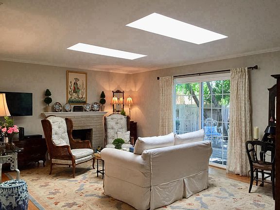 Large Living Room with slider to deck and skylights. 
