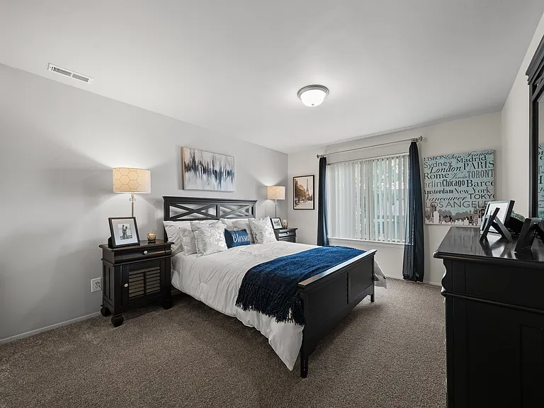 Spacious bedroom with ample storage space at Knottingham Apartments in Clinton Township, MI.