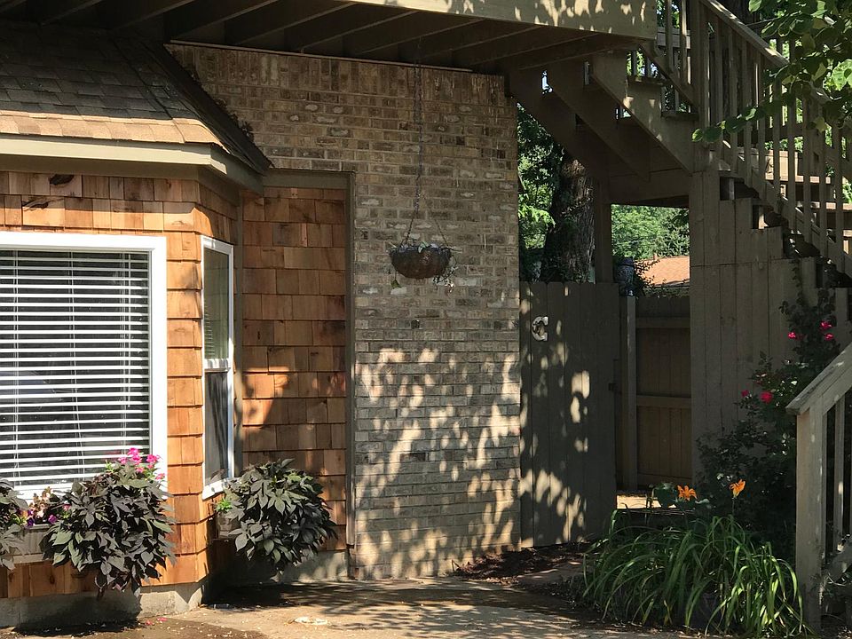 Entrance to private yard thru gate from driveway. Living room bay window.