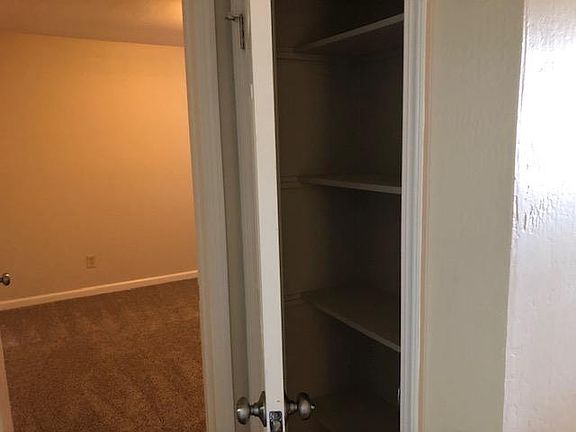 Outside the second bedroom is a linen closet; door to main bedroom is at left of this photo.