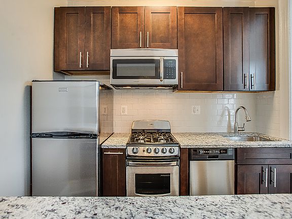 Renovated kitchen with stainless steel appliances and granite countertops