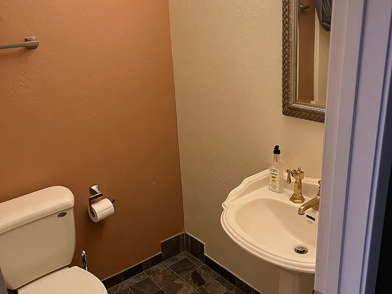 tile floor and new fixtures make small bathroom pleasant. Older shower-in-bath to your left