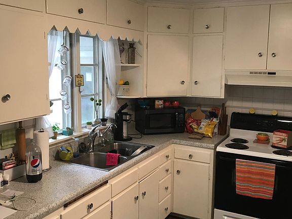 Kitchen; looking to sink and stove.