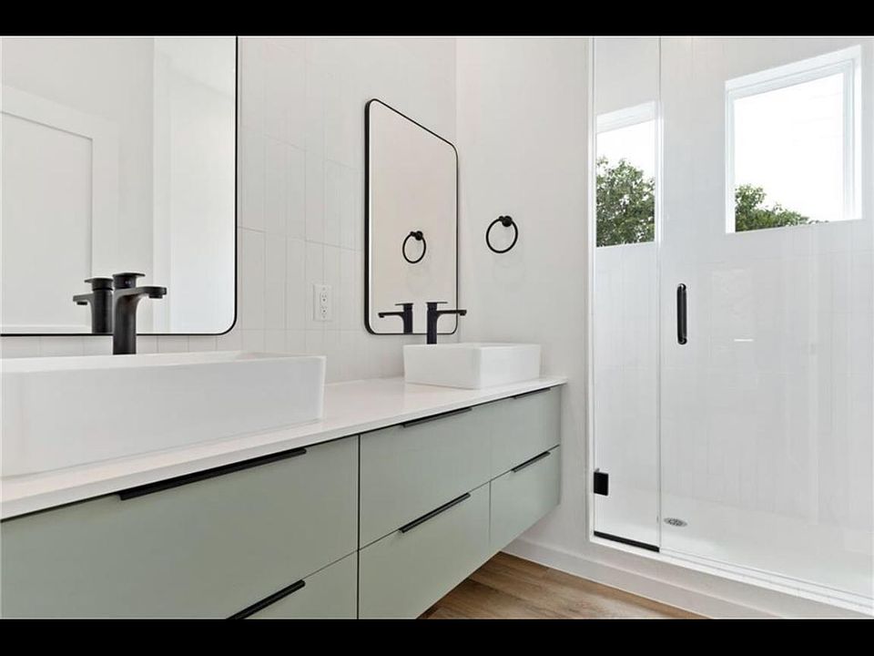 Full-bathroom #1 with 2 sinks, standing shower, and toilet