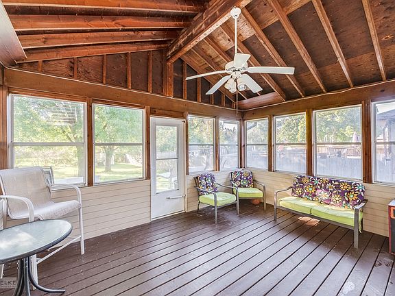 You'll love this amazing enclosed porch w/vaulted ceiling, fan & access to deck & lovely backyard!