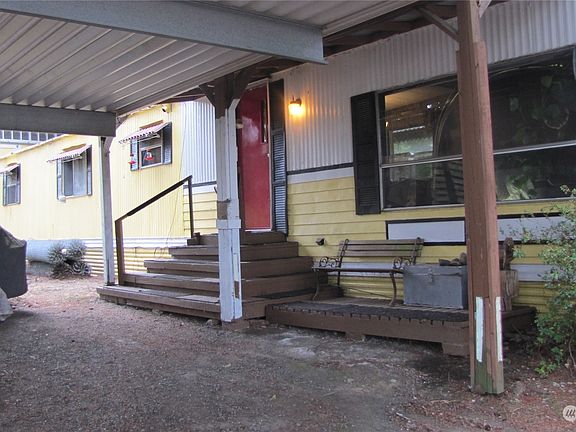 Covered carport also gives you coverage to the front door. No getting wet from your car!>