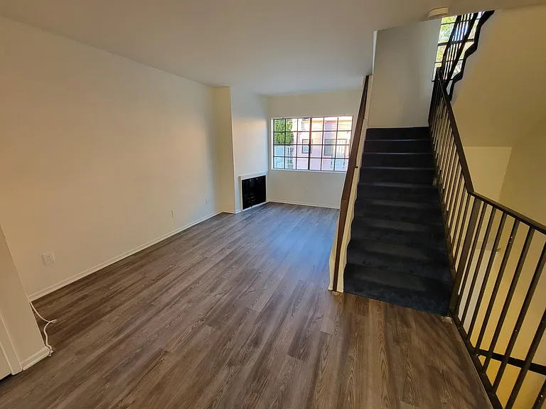 Living Rm, Gas Fireplace, Window View and Stairs to Bedrooms/Bathrooms