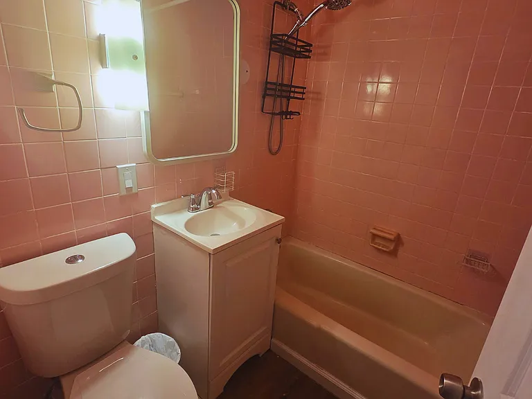 Fully equipped bathroom with a shower, towels, mirror and essentials.