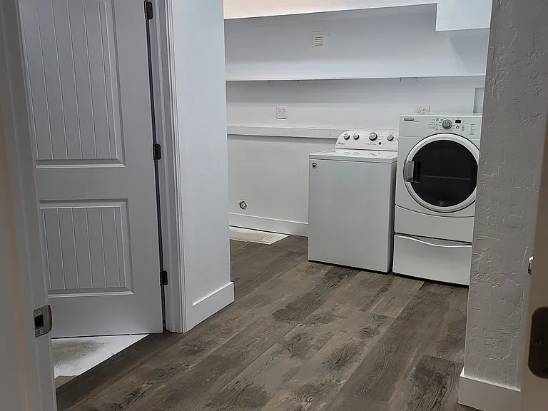 Laundry room with walk in storage