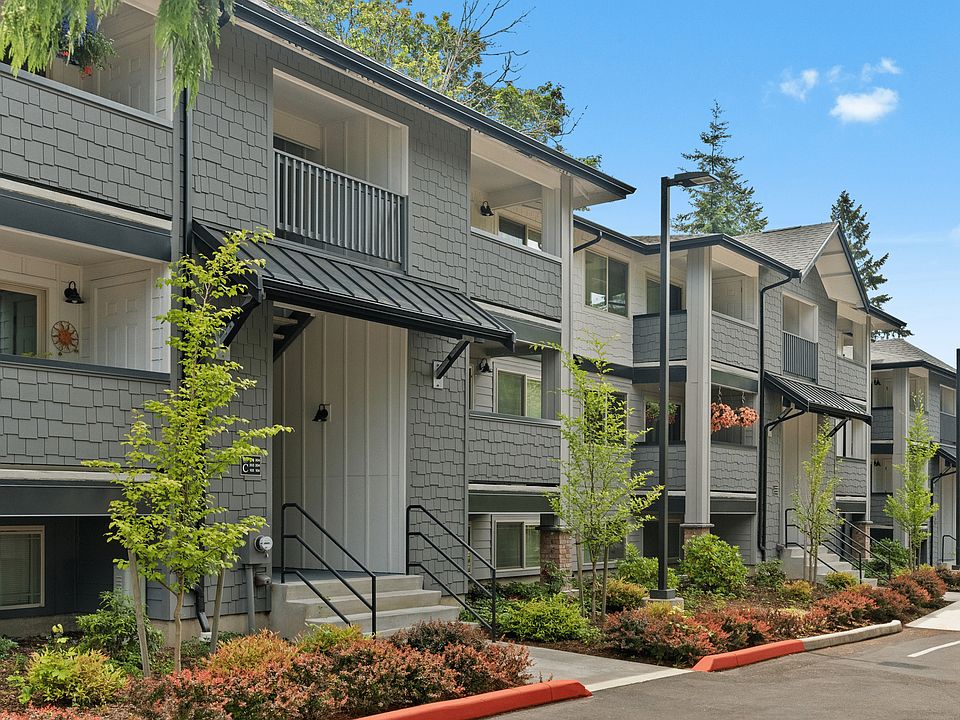 Modern apartment exteriors with lush greenery.