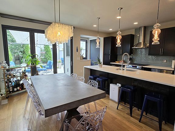 Dining Area with 8 Person Table - trifold doors open onto patio