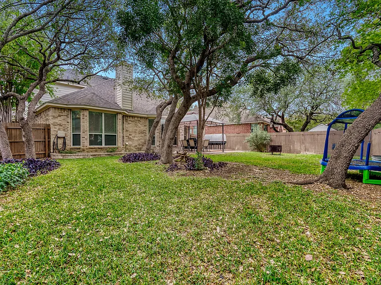 mature trees in this private backyard oasis