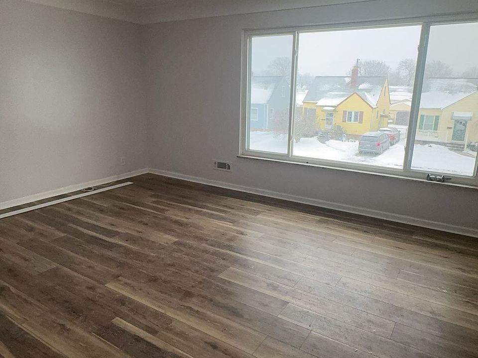 Spacious living room with large sun facing windows