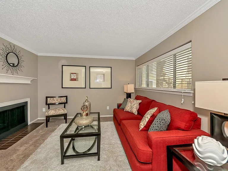 Living room with cozy fireplace and modern finishes in select apartment homes