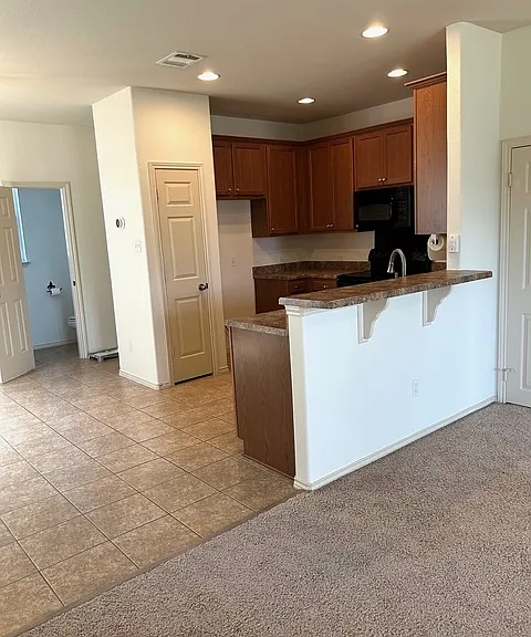 Recessed lighting and oversized cabinets, bar seating