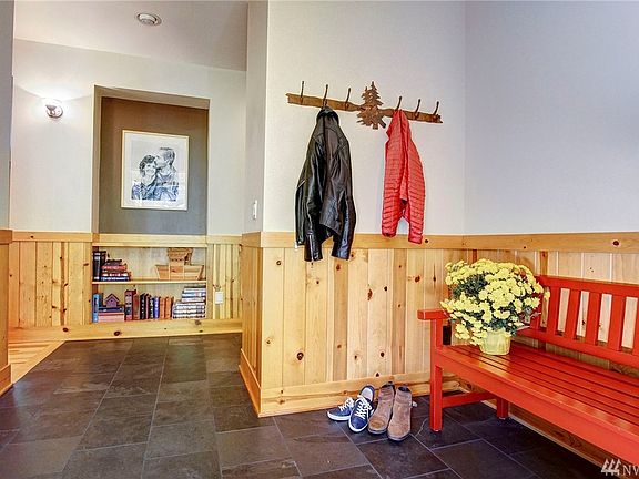 Large front foyer with slate tile floor allows room for a bench and is private from the rest of the home.  Notice the built in art nook and built-in bookshelf!
