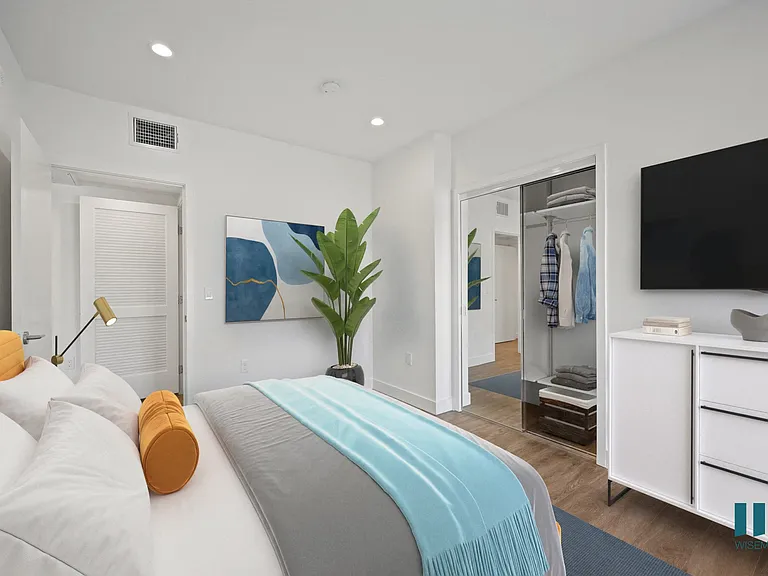 Bedroom with Closet with Built-In Shelving, Vinyl Flooring, and Recessed Lighting