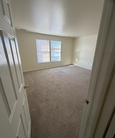 Bedroom one with double window and 2 closets