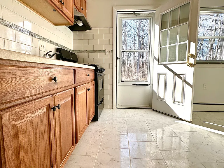 Eat-in kitchen features ceramic tile floor, private rear entrance to back yard.