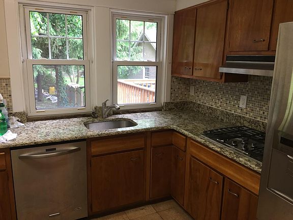 Brand New Granite Counter Tops, refinished wood cabinets, an