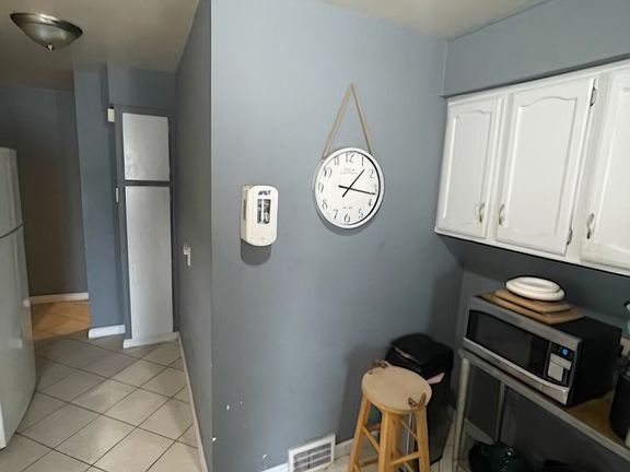 The kitchen now has updated cabinets and has been freshly painted in a cream color to better match your decor.