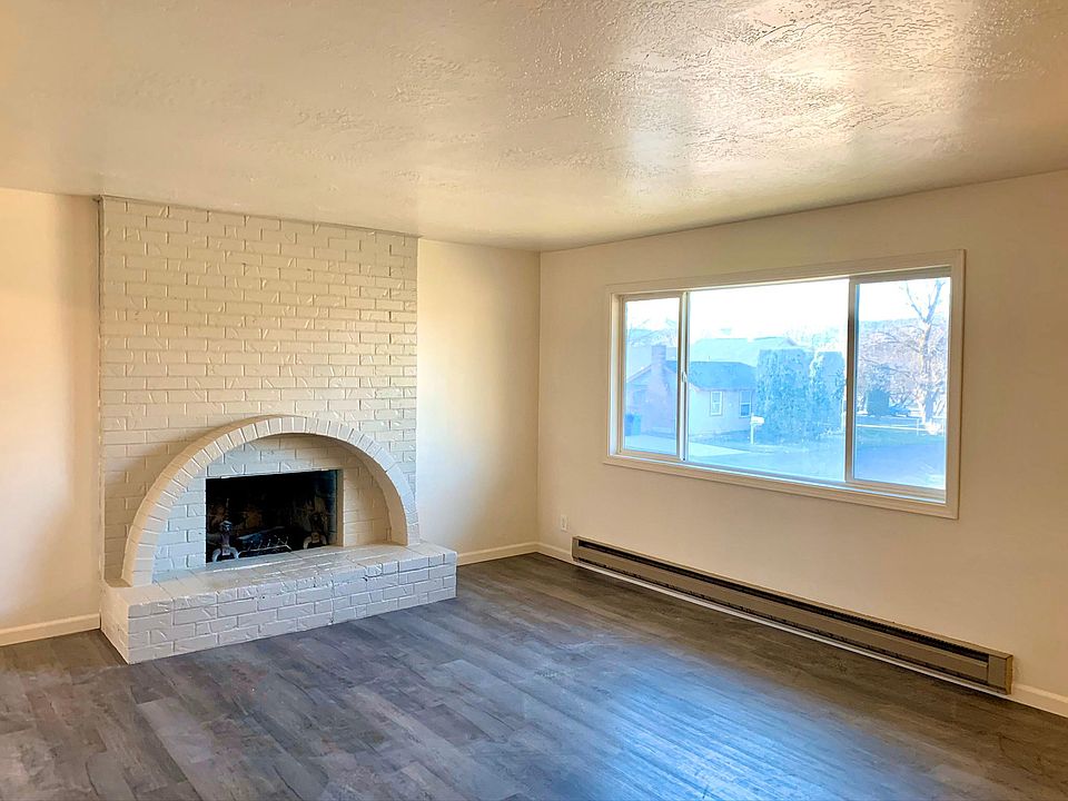 Spacious upstairs living room which boasts natural light. Complete with a fireplace. Home also has a downstairs living room with a fireplace and large window.