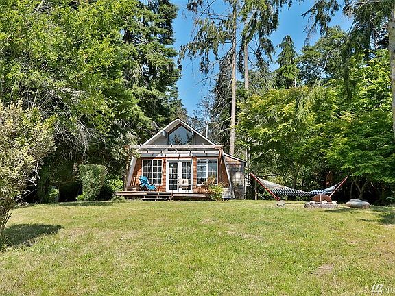 The lot is fairly level with trees and shrubs as a greenbelt for privacy.