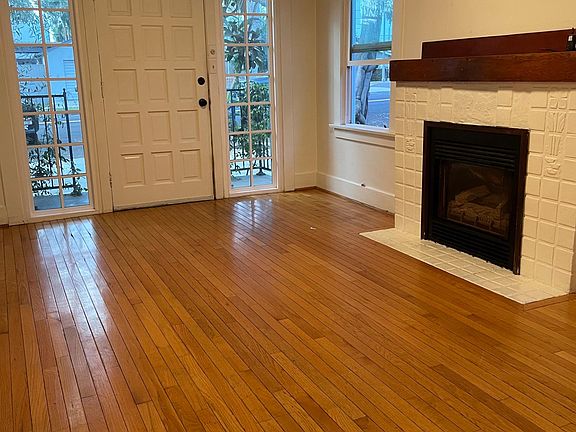 Living room vacant, note fireplace is now decommissioned.