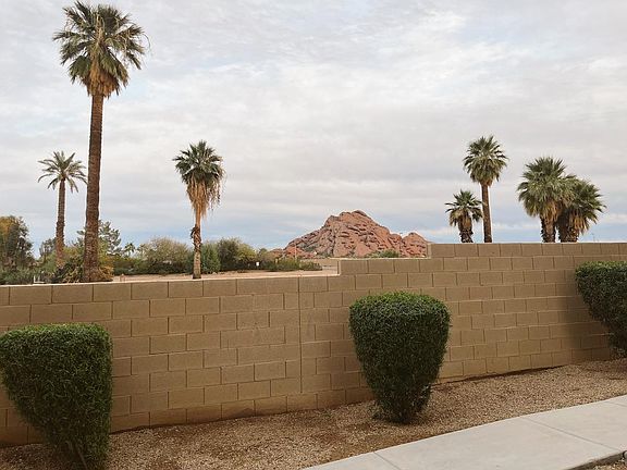 Stunning view of Papago Buttes seen from the front door, first-level bedroom, second-story patio, and master bedroom.