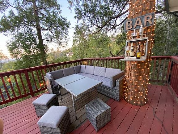 Outdoor seating with murphy bar on our tree growing into our patio