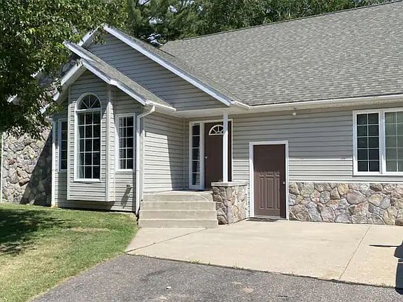 Front of home, has long driveway down to the road