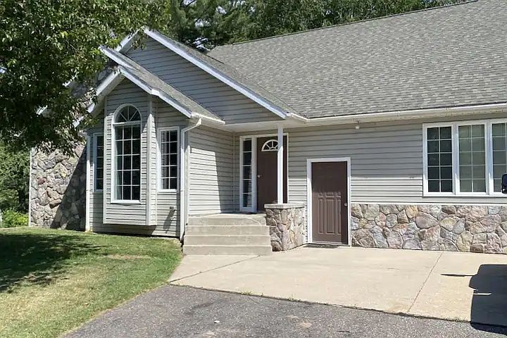 Front of home, has long driveway down to the road