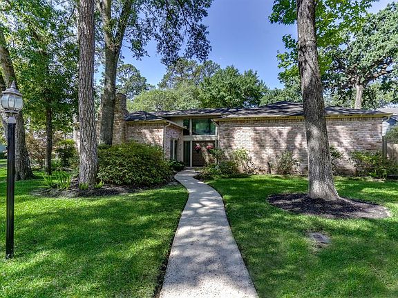 Home is nestled among mature trees, with curb appeal and much more. Beautiful azaleas will give you much enjoyment in the spring