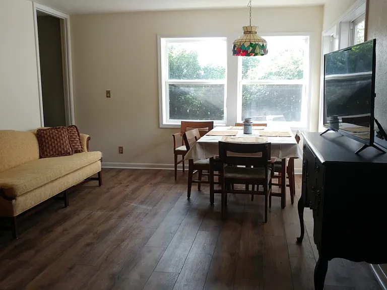 Downstairs gathering area off of kitchen. Table and TV included
