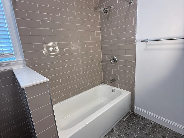 bathtub with pony wall separating toilet area