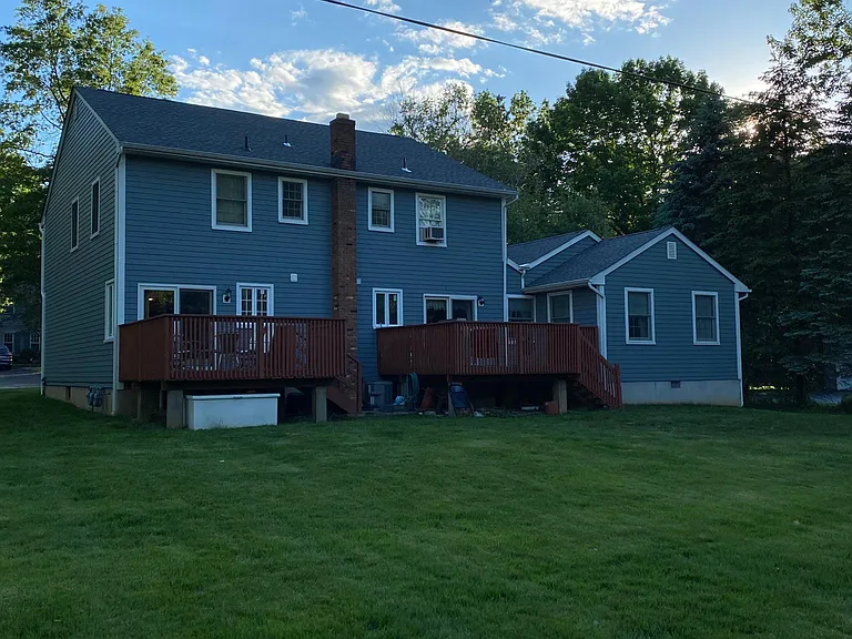 Large backyard and outdoor deck space.