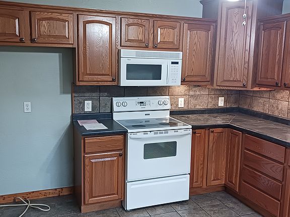 Location for a refrigerator (not provided.) Enter the living room to the left of this photo.