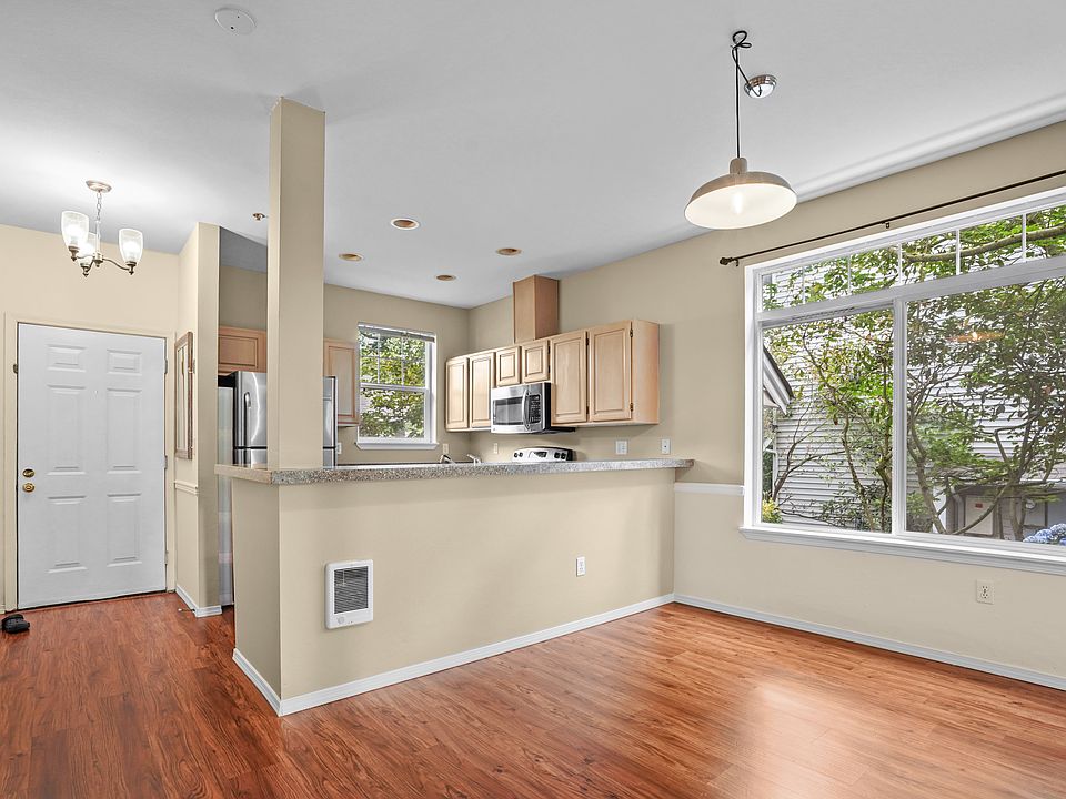 Kitchen view from living room. Entrance to the house to the left.